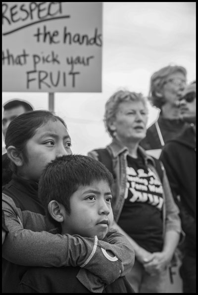 BURLINGTON, WA - 11JULY15 - Farm workers and their supporters march to the office of Sakuma Farms, They are demanding that the company bargain a contract with their union, Familias Unidas por la Justicia. The workers are indigenous migrants from Oaxaca, in southern Mexico. Copyright David Bacon