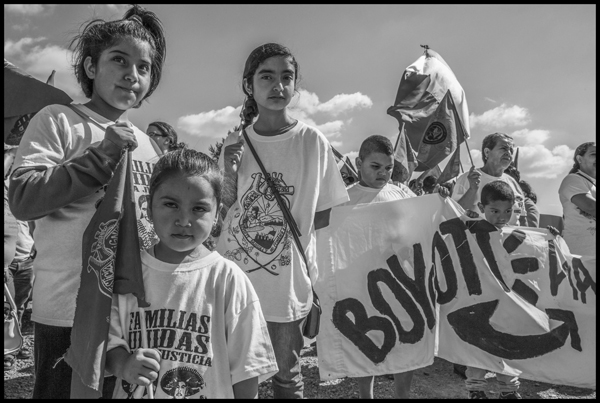  BURLINGTON, WA - 11JULY16 - Migrant farm workers and their supporters march to the processing plant at Sakuma Brothers Farms. Copyright David Bacon