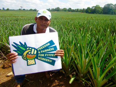 Farmer Holds Sign: Freedom and Fairness for Fyffes Workers