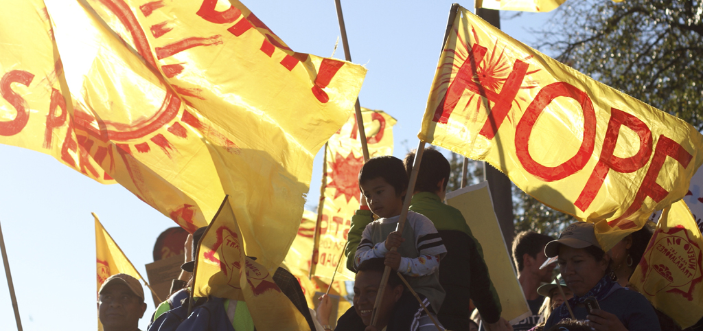 CIW protest - foodworkers protest on the streets waving flags