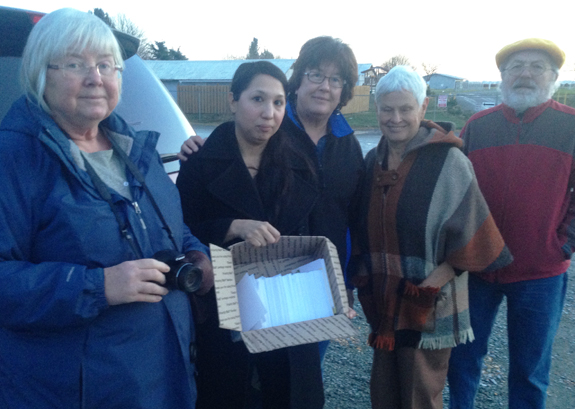 Representatives of the National Farmworker Ministry hold box of 750 postcards